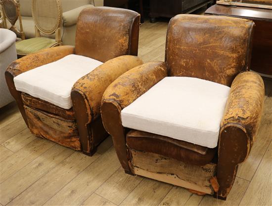 A pair of brown leather upholstered club armchairs